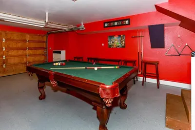 a pool table in a room with red walls at Fawnskin Chalet-1826 by Big Bear Vacations in Fawnskin