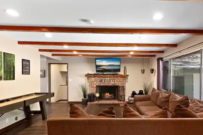 a living room with a couch and a fireplace at Mountain Fun-1729 by Big Bear Vacations in Big Bear Lake