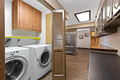 a kitchen with a washing machine and a refrigerator at Mountain Fun-1729 by Big Bear Vacations in Big Bear Lake