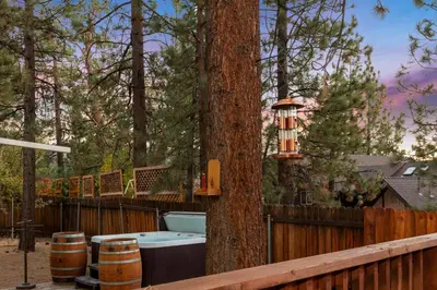 a bath tub sitting next to a tree at Mountain Fun-1729 by Big Bear Vacations in Big Bear Lake