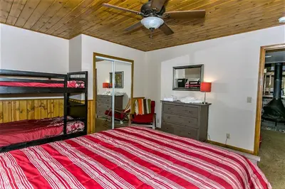 a bedroom with a bed and a ceiling fan at Grandpas Axe-1775 by Big Bear Vacations in Big Bear Lake