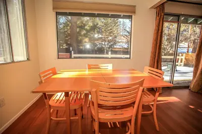 a dining room with a wooden table and chairs at Cozy up to Summit-1651 by Big Bear Vacations in Big Bear Lake