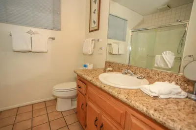 a bathroom with a sink and a toilet and a mirror at Cozy up to Summit-1651 by Big Bear Vacations in Big Bear Lake
