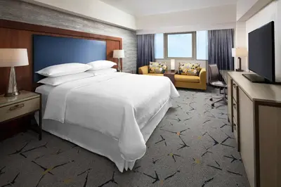 a hotel room with a large bed and a television at Sheraton Gateway Los Angeles Hotel in Los Angeles