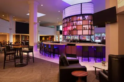 a bar in a restaurant with chairs and tables at Sheraton Gateway Los Angeles Hotel in Los Angeles