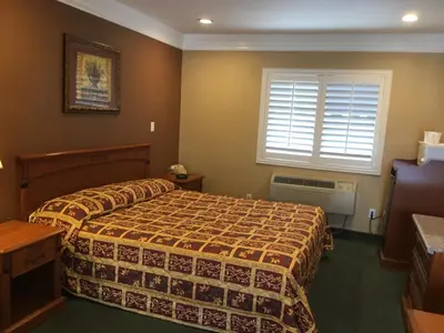 a hotel room with a bed and a window at Beverly Inn in Los Angeles