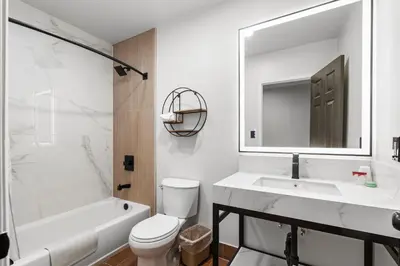 a bathroom with a sink and a toilet and a mirror at Beverly Inn in Los Angeles
