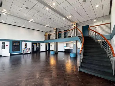 a lobby with a staircase in a building at Motel 6-Carson, CA in Carson