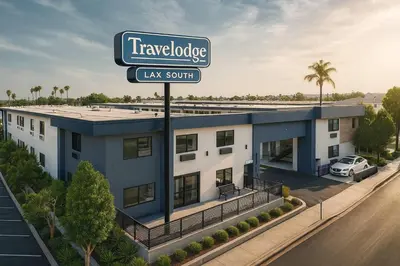a building with a street sign in front of it at Travelodge by Wyndham LAX in El Segundo