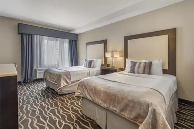 a hotel room with two beds and a large window at Best Western Plus Hotel at the Convention Center in Long Beach