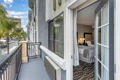 a balcony of a hotel with a bed and a bedroom at Best Western Plus Hotel at the Convention Center in Long Beach