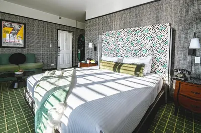 a bedroom with a large bed in a room at The Hollywood Franklin Hotel near Universal Studios in Los Angeles