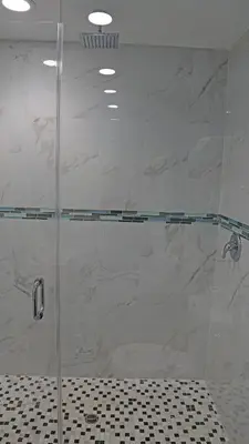 a shower with a glass door in a bathroom at Surf City Inn in Huntington Beach