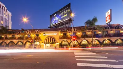 a building with a billboard on top of it at night at Best Western Plus Sunset Plaza Hotel in Los Angeles