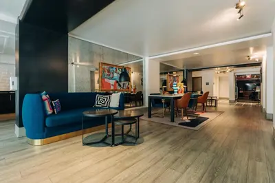 a living room with a blue couch and tables at Montrose at Beverly Hills in Los Angeles