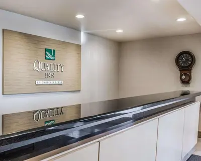 a kitchen with a counter and a clock on the wall at Quality Inn Rosemead-Los Angeles in Rosemead
