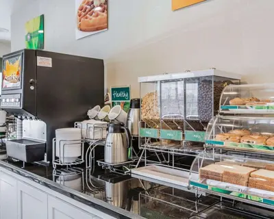 a bakery counter with a bunch of pastries and bread at Quality Inn Rosemead-Los Angeles in Rosemead