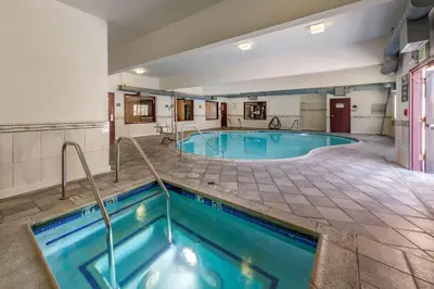 a large indoor pool in a hotel room at Citrus Suites Redlands Loma Linda Hotel in Redlands