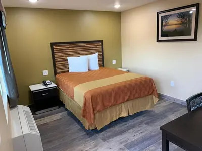 a hotel room with a bed and a television at GAREY MOTEL in Pomona
