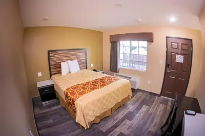 a hotel room with a bed and a window at GAREY MOTEL in Pomona