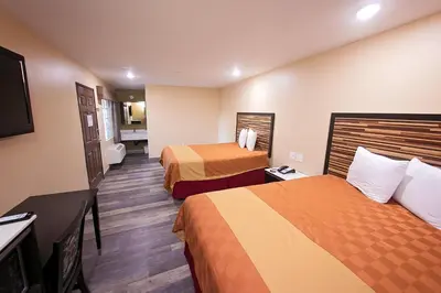 a hotel room with two beds and a flat screen tv at GAREY MOTEL in Pomona