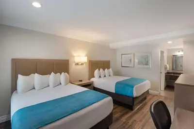 a hotel room with two beds and a bathroom at Best Western Woodland Hills in Woodland Hills