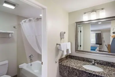 a bathroom with a sink and a mirror at Best Western Woodland Hills in Woodland Hills