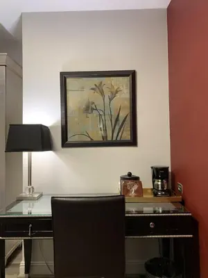 a desk in a room with a picture on the wall at L.A. Sky Boutique Hotel in Los Angeles