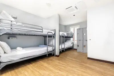 a room with three bunk beds in it at HI Los Angeles Santa Monica Hostel in Los Angeles