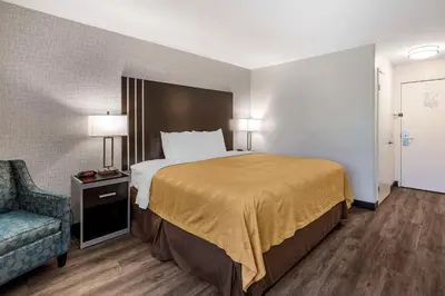 a hotel room with a bed and a chair at Quality Inn Burbank Airport in Burbank