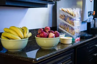 two bowls of fruit on a counter in a kitchen at Quality Inn Burbank Airport in Burbank