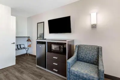 a hotel room with a chair and a tv at Quality Inn Burbank Airport in Burbank