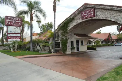 a building with signs on the side of it at Dynasty Suites Redlands in Redlands