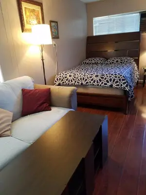 a living room with a couch and a bed at Woodland Hills BEST Priced Room in Woodland Hills