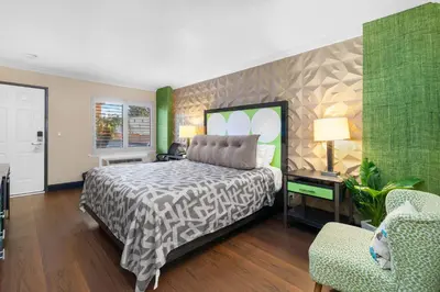 a bedroom with a bed and a desk and a chair at Santa Clarita Motel - Near six Flags Magic Mountain - Valencia in Santa Clarita