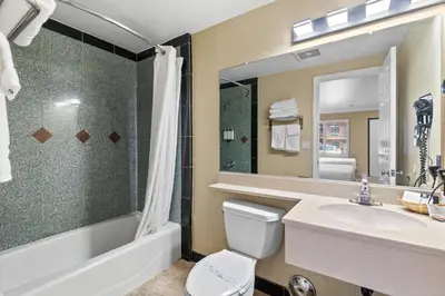 a bathroom with a sink and a tub and a toilet at Santa Clarita Motel - Near six Flags Magic Mountain - Valencia in Santa Clarita