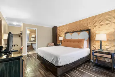a bedroom with a bed and a desk and a television at Santa Clarita Motel - Near six Flags Magic Mountain - Valencia in Santa Clarita