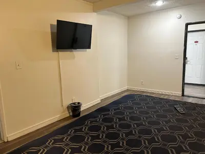 a room with a flat screen tv on the wall at Budget Inn Hollywood in Los Angeles