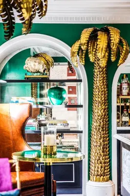 a green room with a table and a mirror at The Prospect Hollywood in Los Angeles