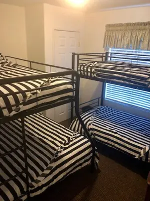 three bunk beds in a room with a window at Sequoia National Forest CabinM in Panorama Heights