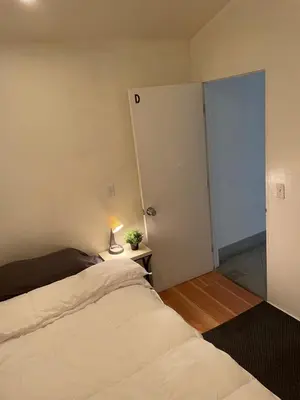 a bedroom with a bed and a lamp on a table at Culver City Hostel in Los Angeles