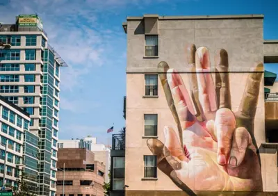 a building with a mural of a hand on it at Angel City 1 bedroom Apartment in Los Angeles