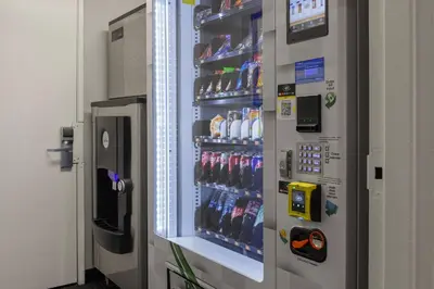 a drink cooler in a store with drinks in it at Peacock Suites in Anaheim