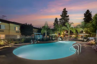 a large swimming pool in front of a building at Best Western Porterville Inn in Porterville