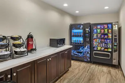 a kitchen with a refrigerator with drinks in it at Best Western Porterville Inn in Porterville