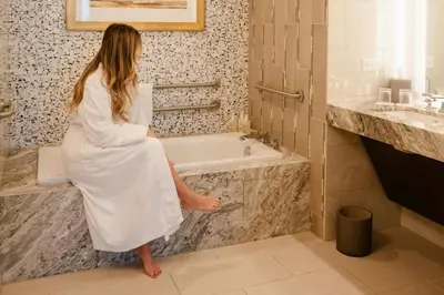 a woman in a white bath tub in a bathroom at JW Marriott, Anaheim Resort in Anaheim