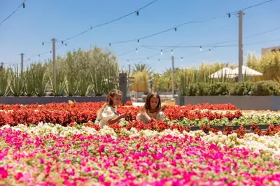two women sitting in a field of flowers at JW Marriott, Anaheim Resort in Anaheim