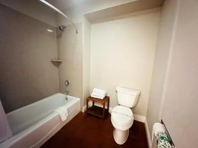 a bathroom with a toilet and a bath tub at Casa Blanca Hotel - Orange in Orange