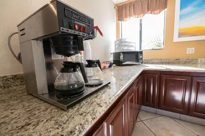 a kitchen with a coffee maker on a counter at Hospitality Inn in San Bernardino