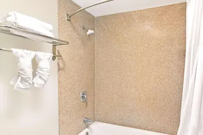 a bathroom with a shower with a shower curtain at Cabana Inn & Suites in Long Beach
